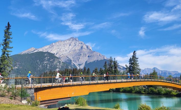 ebikes riding on Bow River Pedestrian Bridge Banff