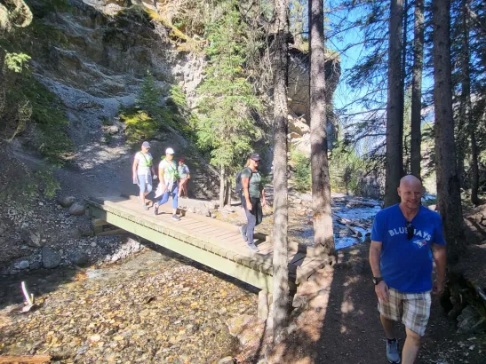 Hikers crossing pedestrian bridge at Sundance Canyon, Banff Canadian Rockies