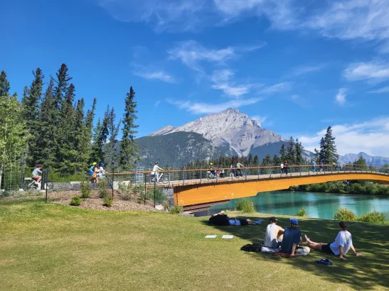 Cyclists on Bow River Pedestrian Bridge, Banff Canadian Rockies