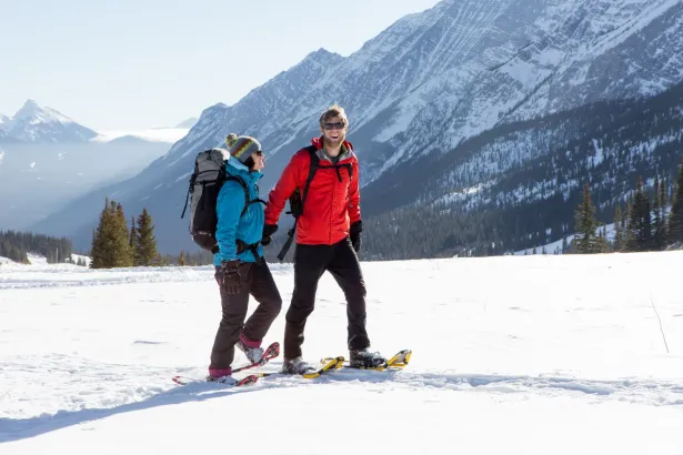 Couple snowshoeing on Fortress Mountain on a sunny winter day