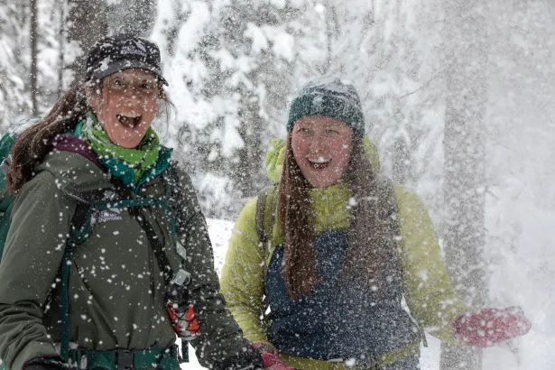 Winter fun at Marble Canyon icewalk with people tossing snow
