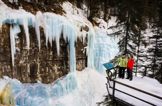 People at Johnston Canyon Icewalk Upper Falls viewing deck