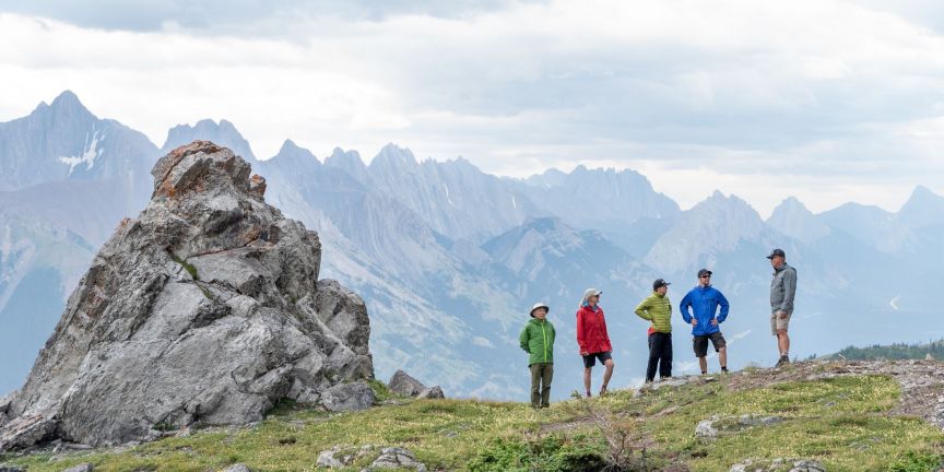 Hikers pause by rock feature on Fortress Ridge in Kananaskis