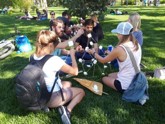 Group building tower with marshmallows and skewers