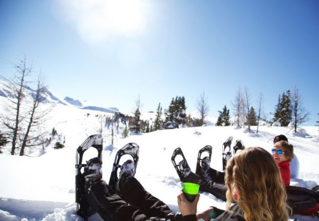 snowshoers enjoying the sun and hot chocolate